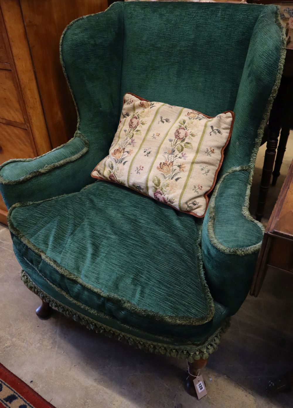 A George III style walnut upholstered wing armchair